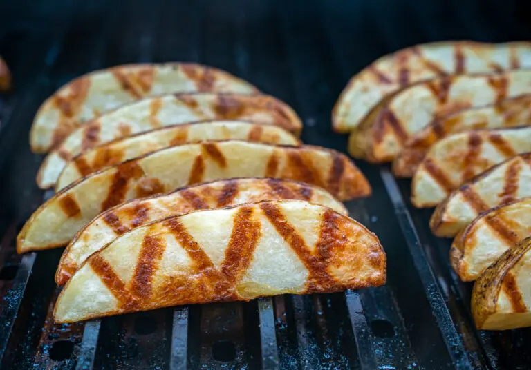 Grilled French fries cooking one a gas grill