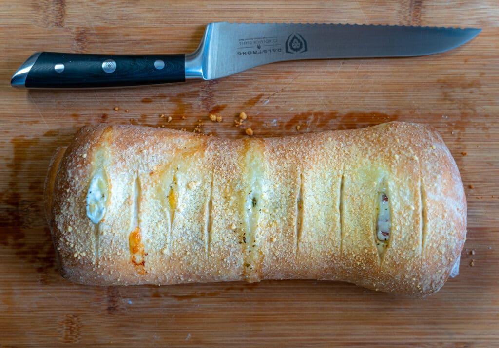 whole pepperoni roll with bread knife