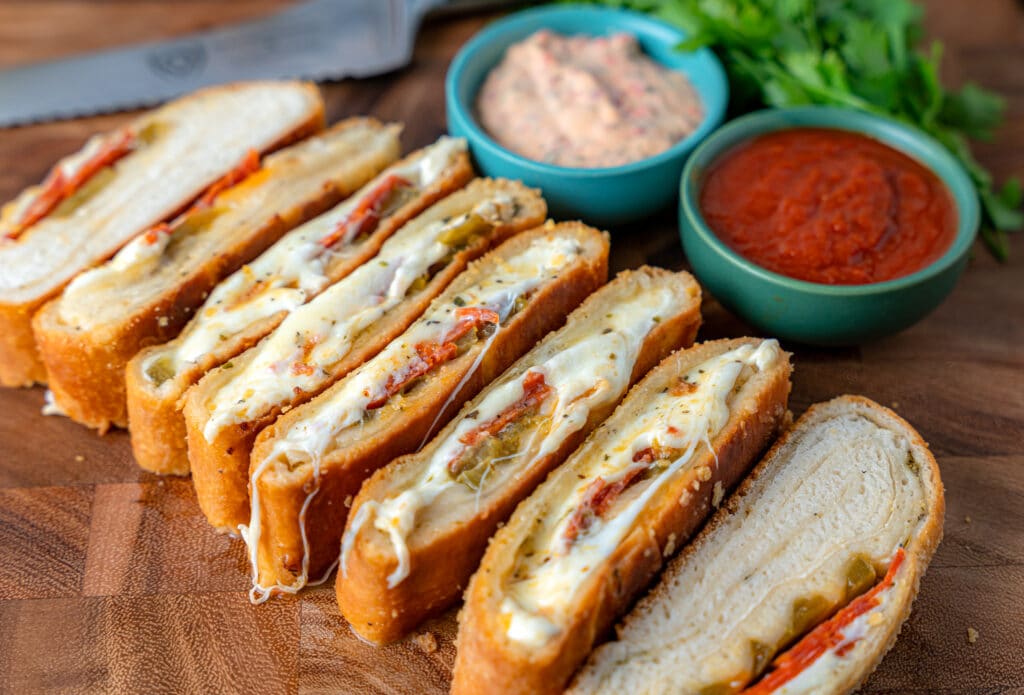 sliced pepperoni roll with dipping sauces