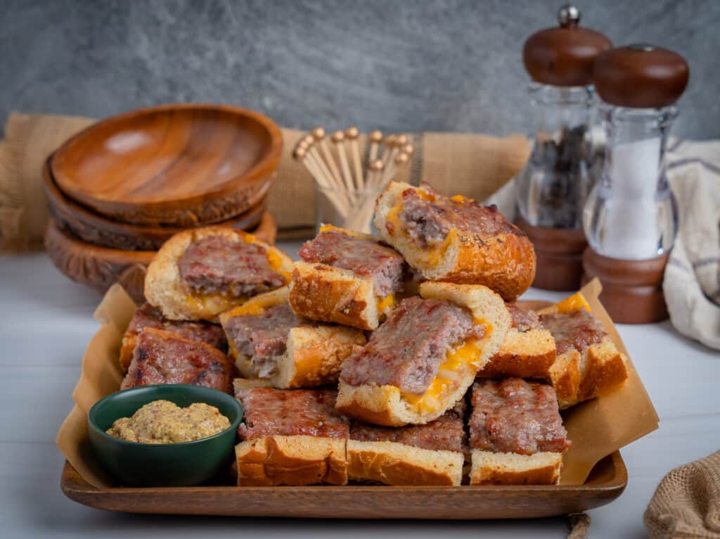 tailgate appetizer tray of brat bread with salt and pepper shakers in the background