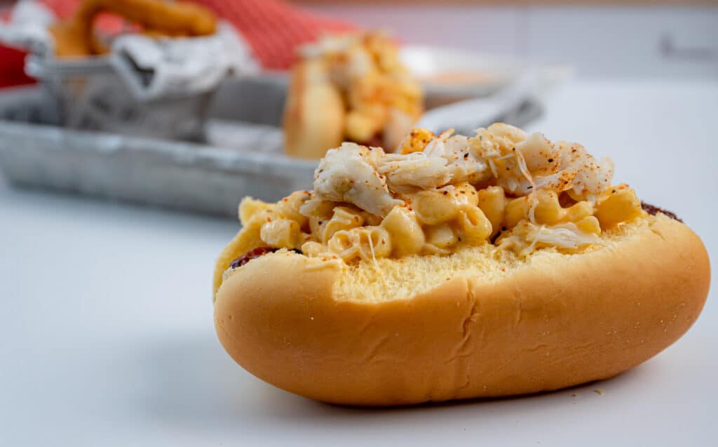 crabmeat on top of a Mac and cheese hot dog