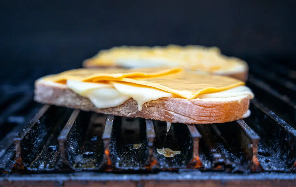 grilled cheese sandwich being made on a grill