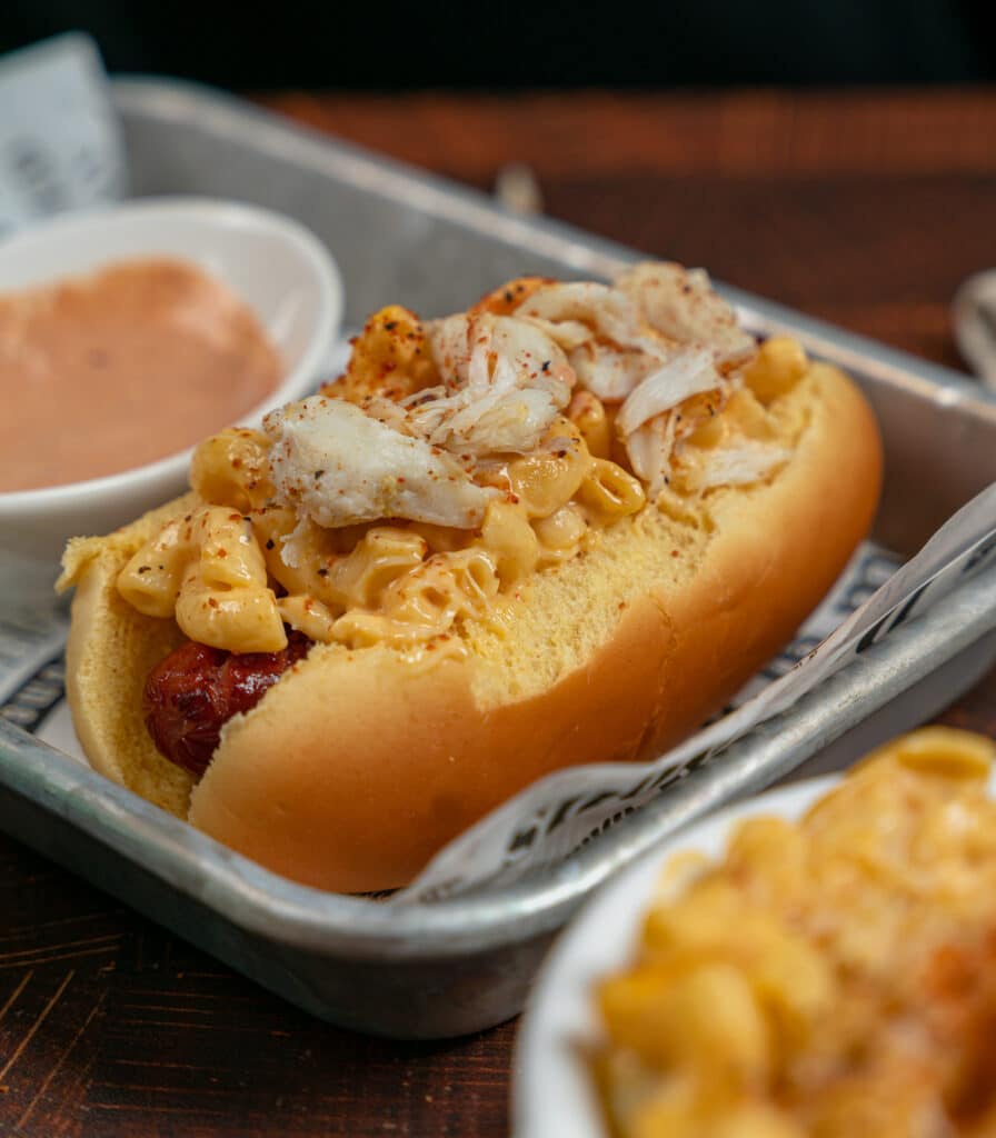 Mac and cheese topped hot dog with jumbo lump crab