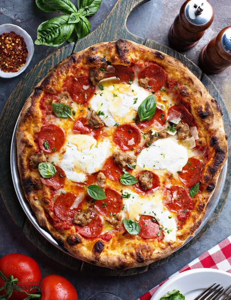 Grilled pizza with mozzarella, pepperoni and basil