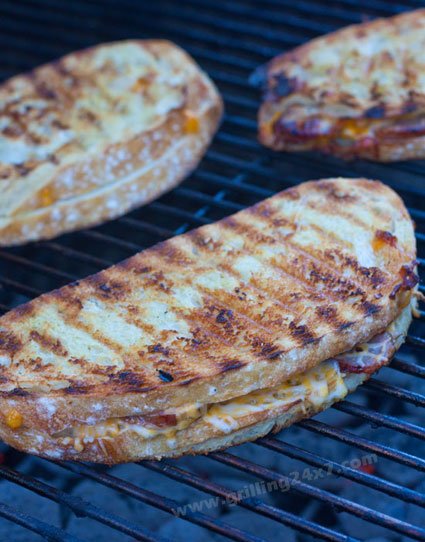 Grilled cheese on the grill with sliced brats
