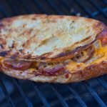 Grilled cheese on the grill with sliced brats