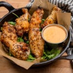 salt and pepper grilled chicken wings in a cast iron skillet
