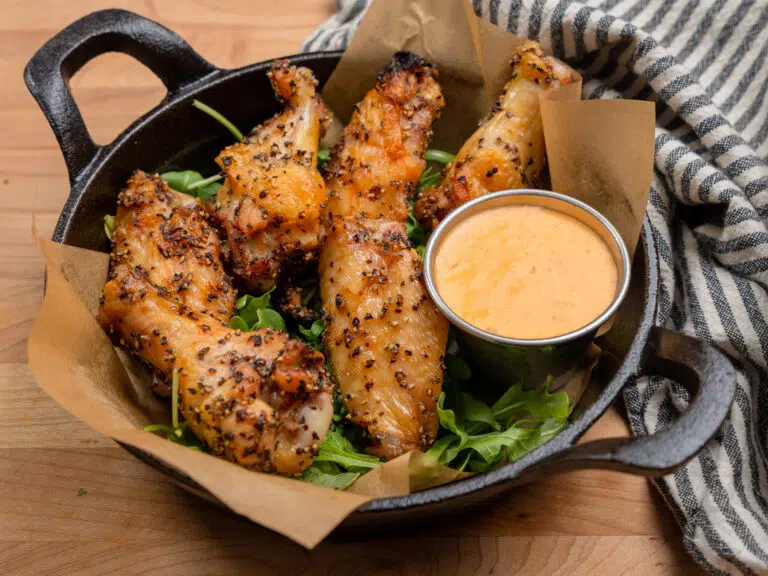 salt and pepper grilled chicken wings in a cast iron skillet