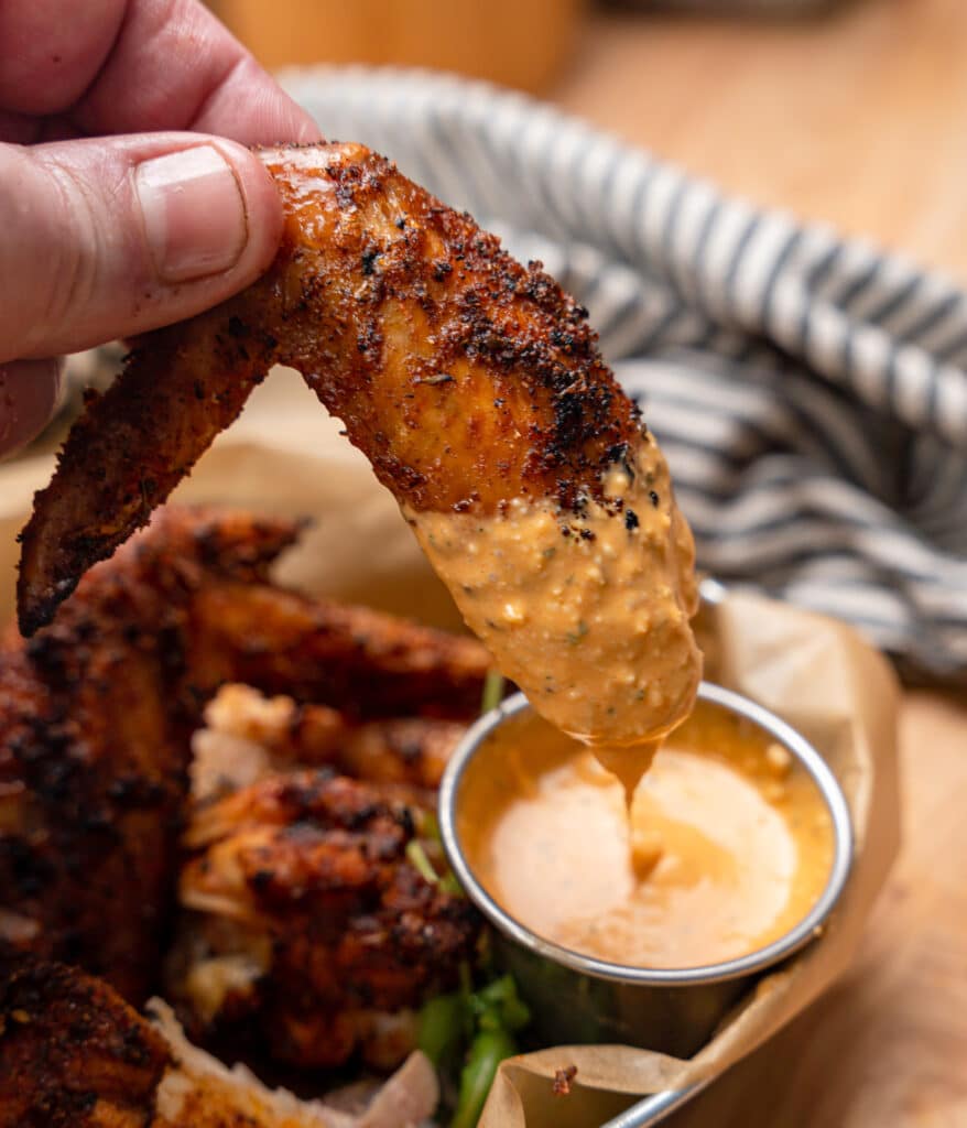 Dipping a whole grilled wings in blue cheese