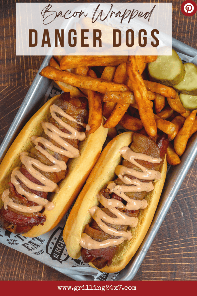 Bacon wrapped danger dogs with fries and pickles on a tray