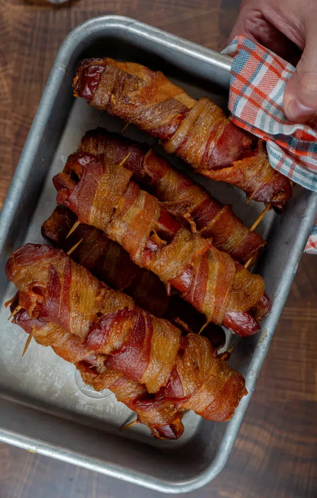 bacon wrapped danger dogs on a tray held together with toothpicks
