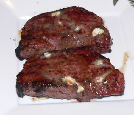 Prime New York Strip Steaks on a charcoal grill - Grilling24x7.com