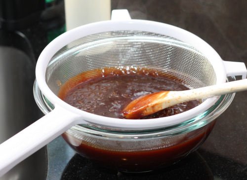 Sweet Whiskey BBQ Sauce in strainer 