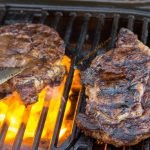 Grilling a steak on a small tailgate grill - Stok Gridiron Review