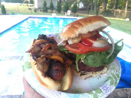 plate with burger and hot dog near pool