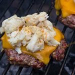 Jumbo Lump Crab Burger Recipe - Lump crab meat with Old Bay on top of a juicy charcoal grilled cheeseburger.