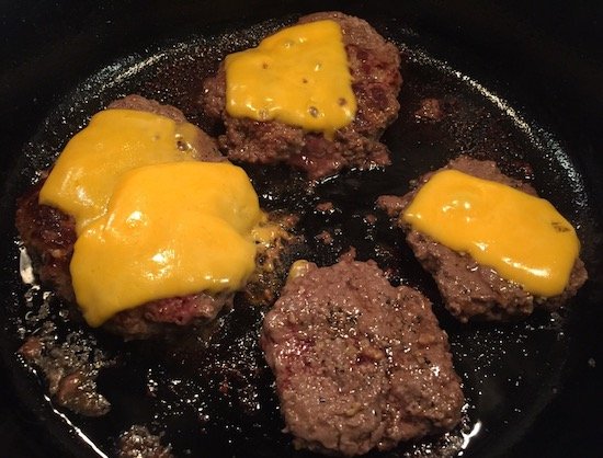 Burgers cooked in a cast iron skillet for seasoning.