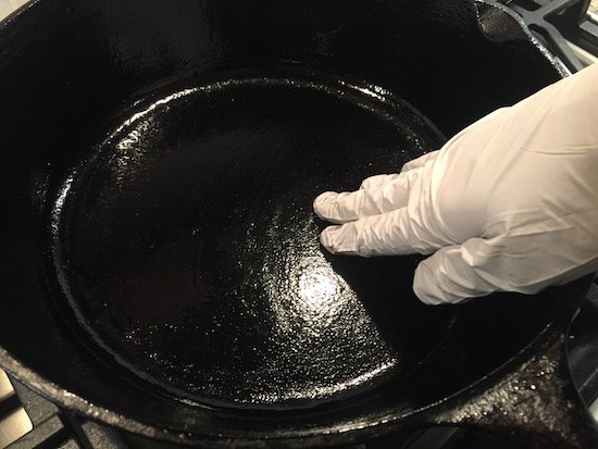 Seasoning a cast iron skillet with bacon grease.