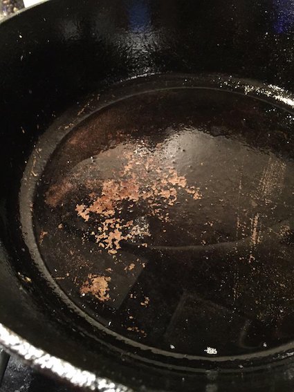 Chipped cast iron skillet with using vegetable oil.