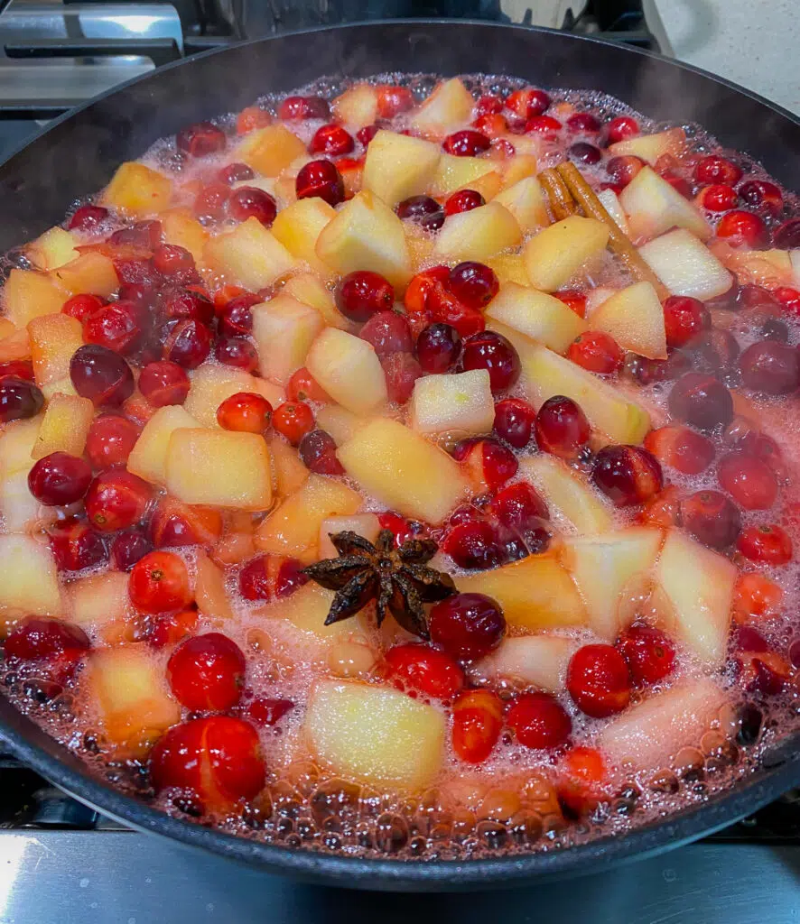 sautéing cranberries and apples in a pan