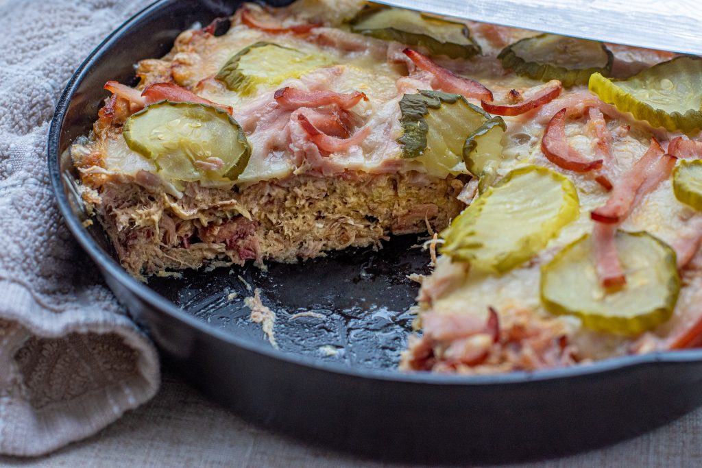 Cuban Casserole in a cast iron skillet with a slice cut out