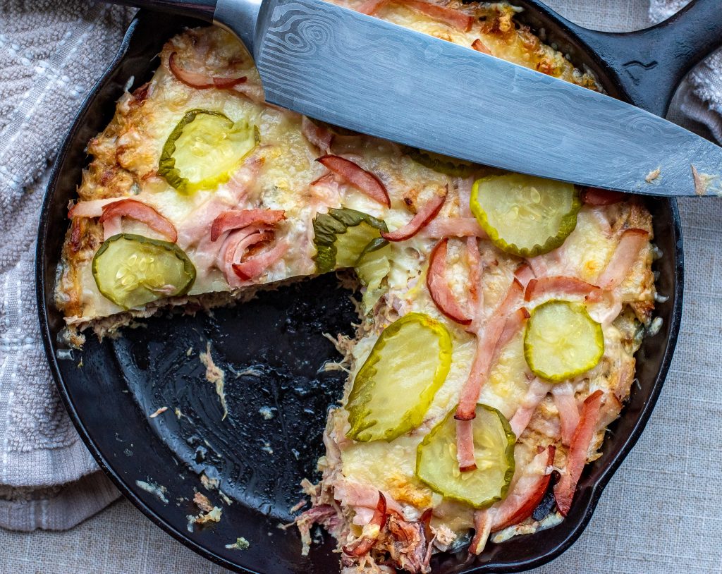 Cuban Casserole in a cast iron skillet with a slice cut out