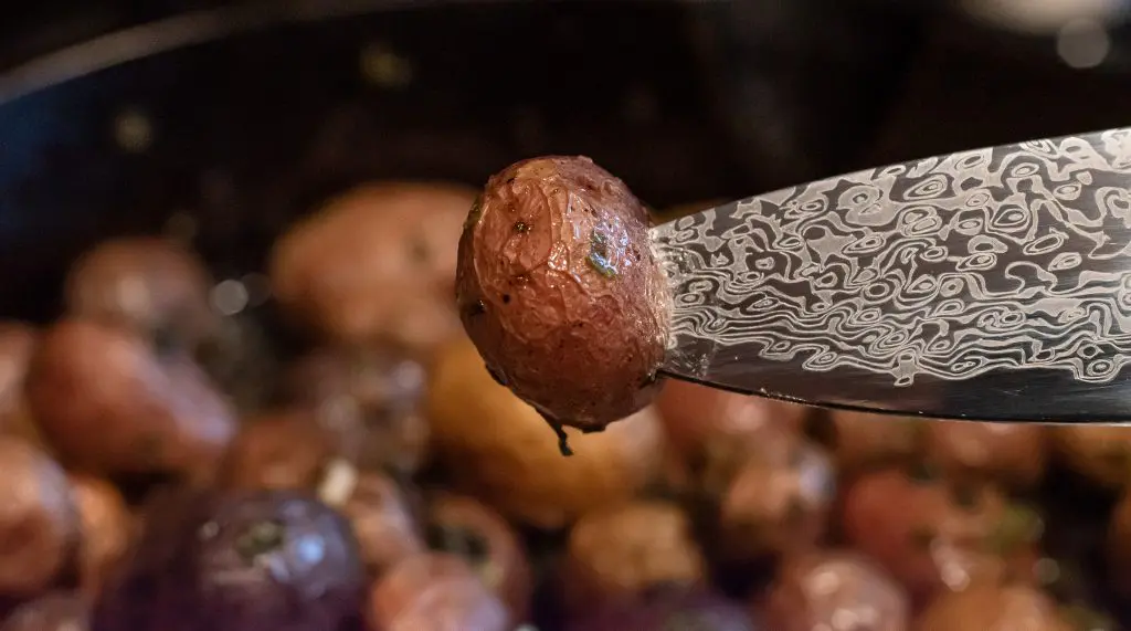 roasted potato on tip of knife