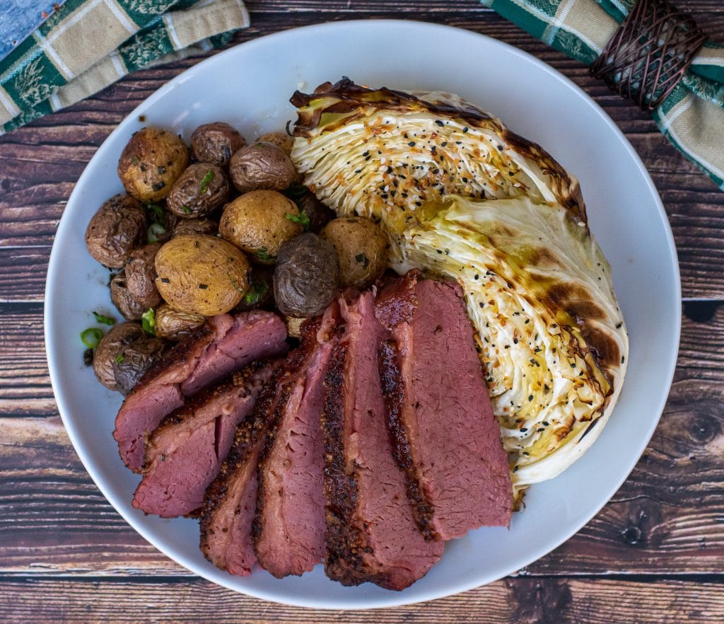 Smoked corned beef with cast iron roasted new potatoes and everything cabbage. the complete st. Patricks day meal