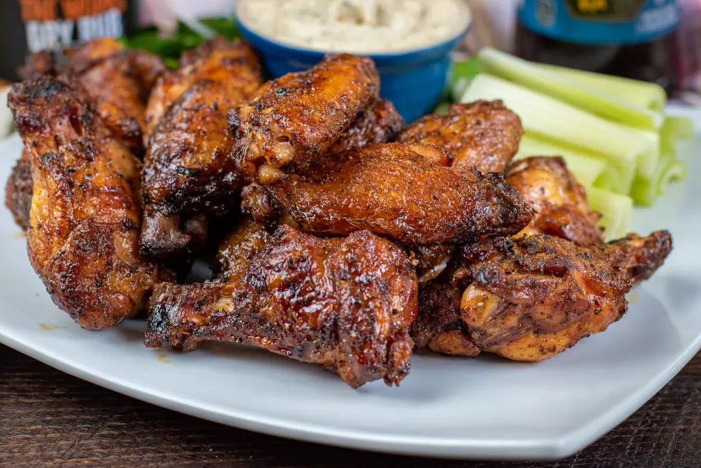 dipped smoked wing in ranch dressing glazed with honey old bay