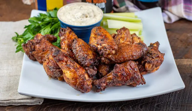 dipped smoked wing in ranch dressing glazed with honey old bay