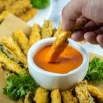 dipping zucchini fries in vodka sauce
