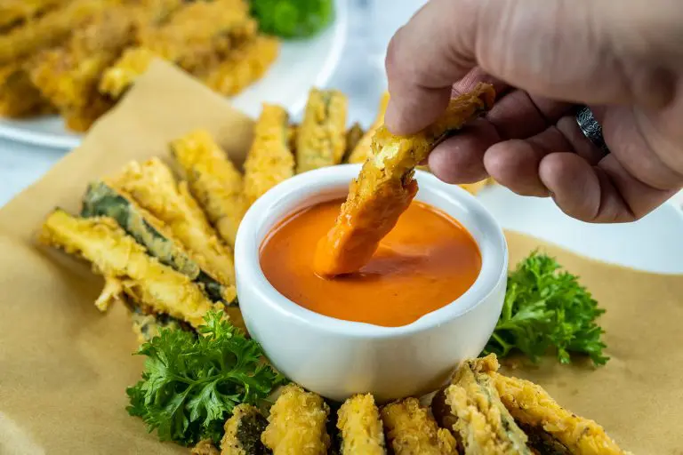dipping zucchini fries in vodka sauce
