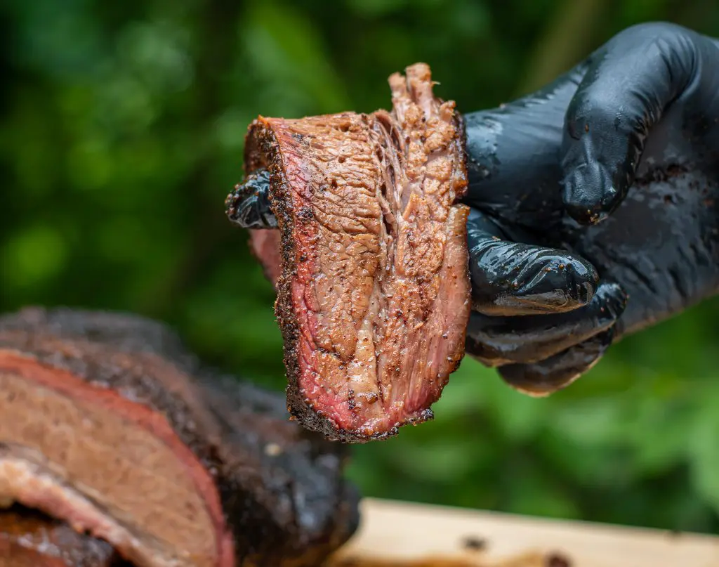 Sliced beef brisket bend test showing tenderness and smoke ring