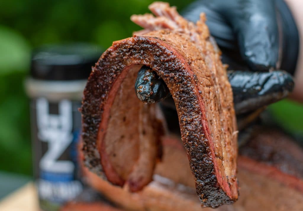 Sliced beef brisket bend test showing tenderness and smoke ring
