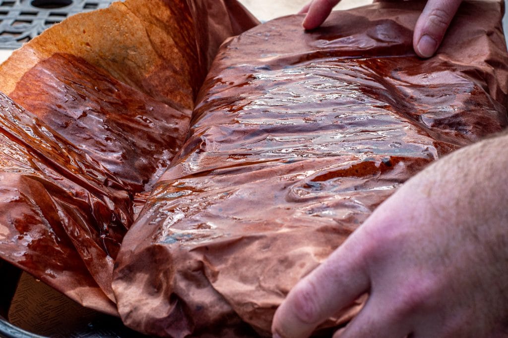smoked beef brisket wrapped in peach butcher paper