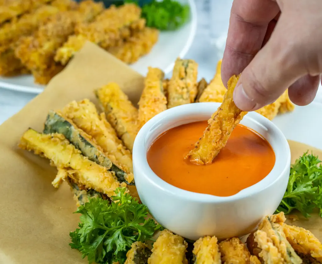 dipping zucchini fries in vodka sauce