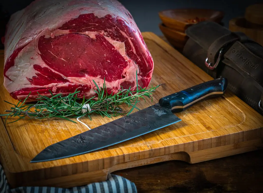 prime rib roast with a folded steel dahlia chef knife