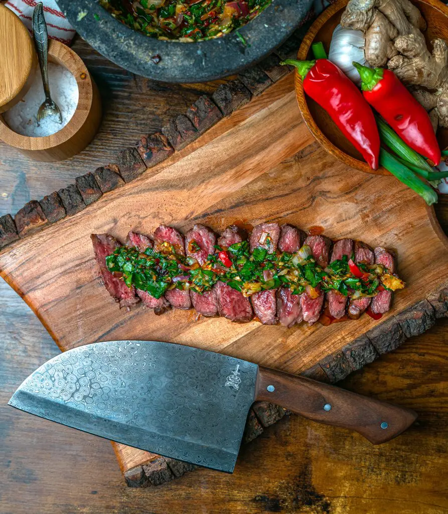 sliced rare Denver Steak topped with chimichurri sauce