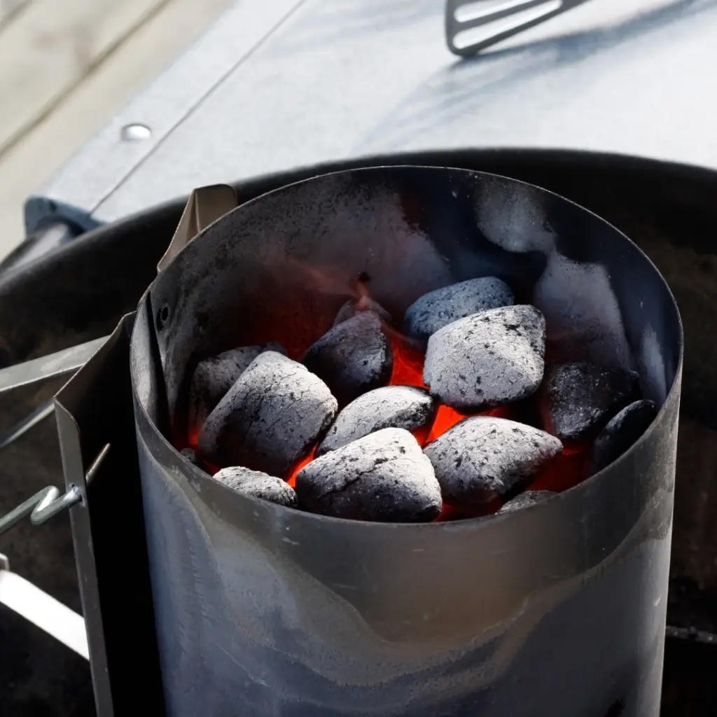 Charcoal chimney filled with charcoal briquettes