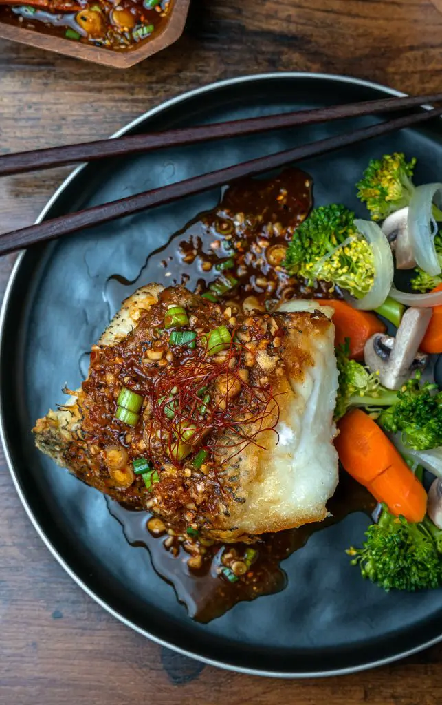 pan seared chilean sea bass served with steamed veggies and hoisin vinaigrette