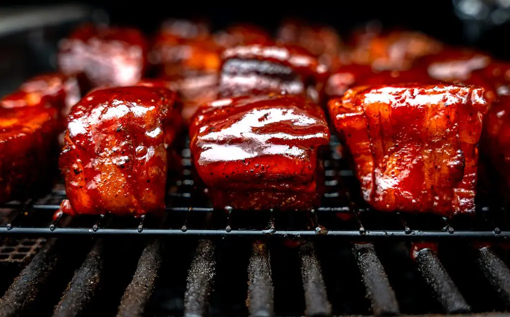 pork belly burnt ends wrapped in bacon and glazed with bbq sauce