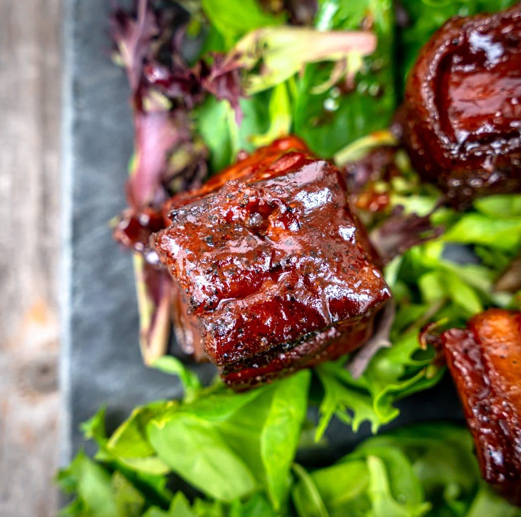 pork belly burnt ends dipped in bbq sauce