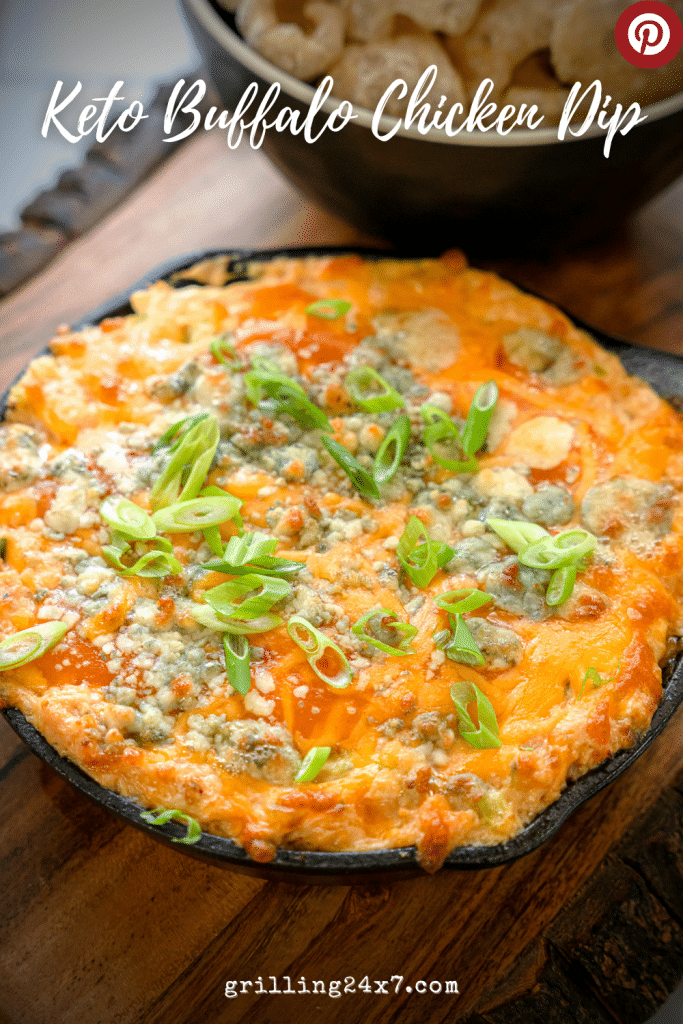 keto buffalo chicken dip served in a cast iron skillet with pork rinds