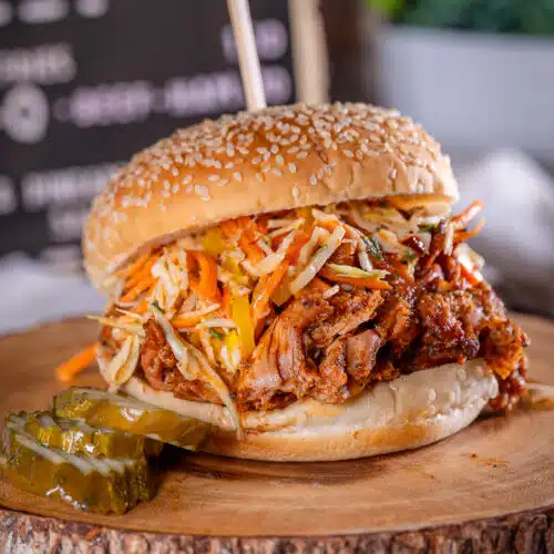 BBQ smoked pulled chicken sandwich on a sesame seed bun