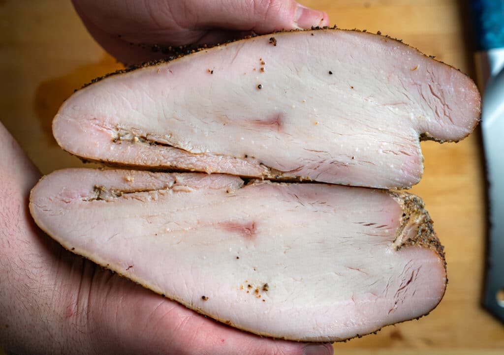 a smoked turkey breast cut in half