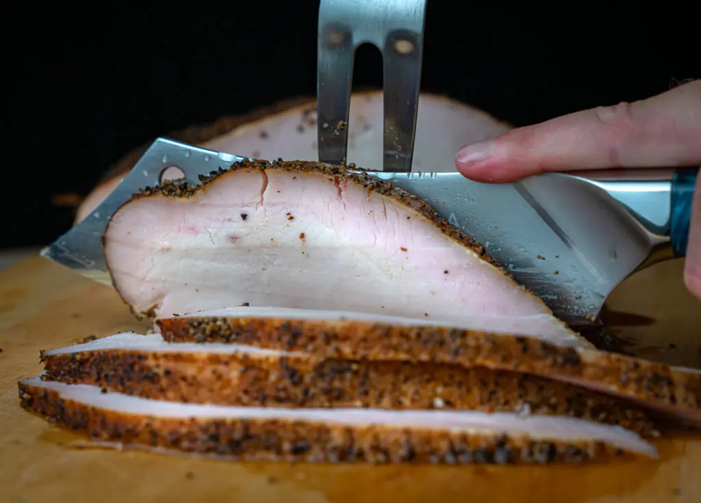 slicing smoked turkey breast