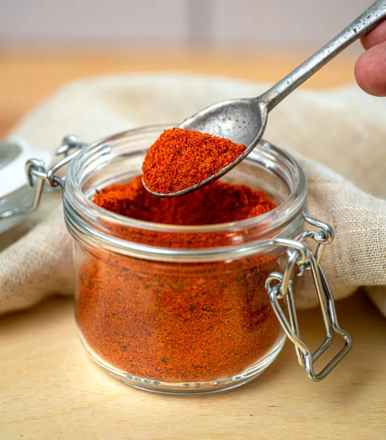 scooping bbq pork dry rub with a spoon