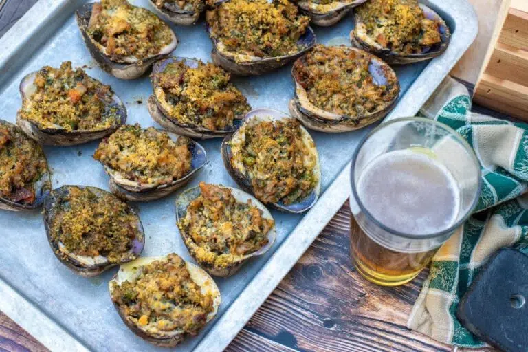 smoked clams casino on a tray with a cold beer