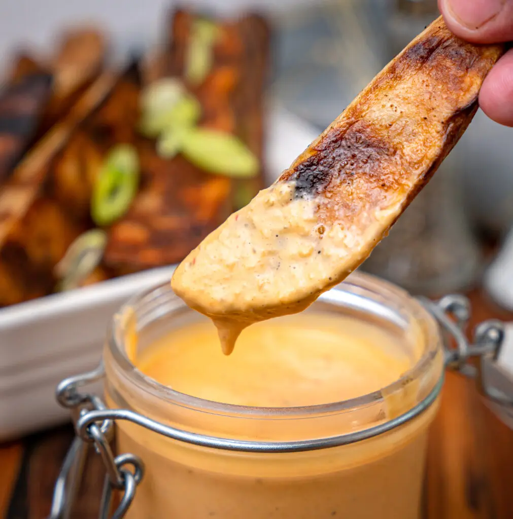 dipping a grilled French frie in comeback sauce