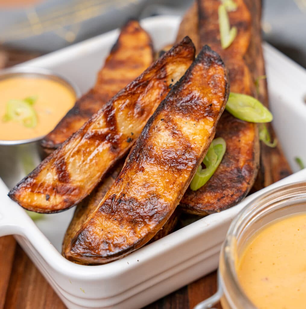 grilled potato wedges garnished with scallions